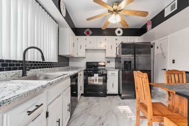 kitchen with light countertops, visible vents, a sink, and black appliances