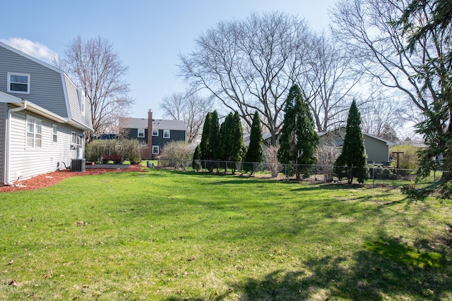 view of yard with fence and central AC