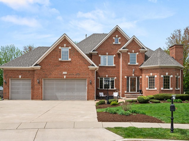 traditional-style house with concrete driveway, a front lawn, brick siding, and a shingled roof