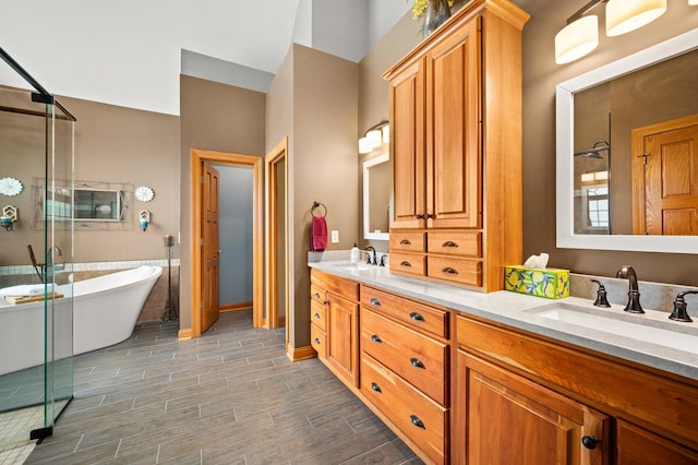 bathroom with a sink, a soaking tub, double vanity, and a shower stall