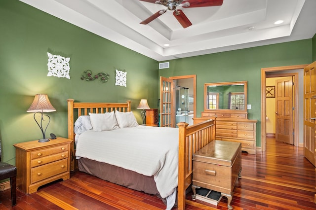 bedroom featuring visible vents, a raised ceiling, hardwood / wood-style floors, and recessed lighting