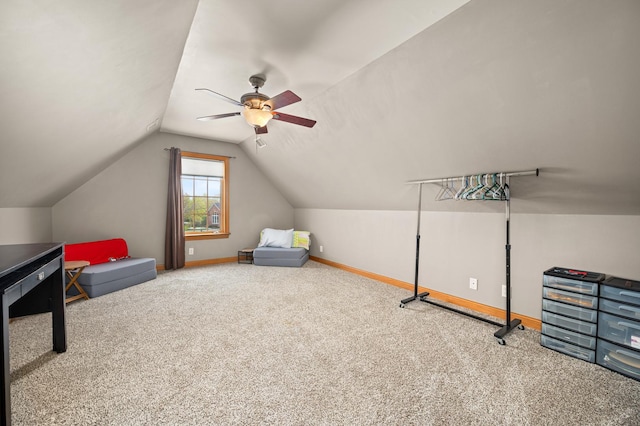 interior space with baseboards, ceiling fan, carpet, and vaulted ceiling