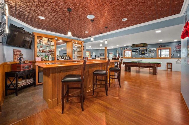 bar featuring a dry bar, billiards, ornamental molding, and an ornate ceiling
