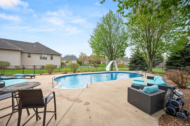 view of swimming pool featuring a fenced backyard, a patio area, a water slide, and a fenced in pool