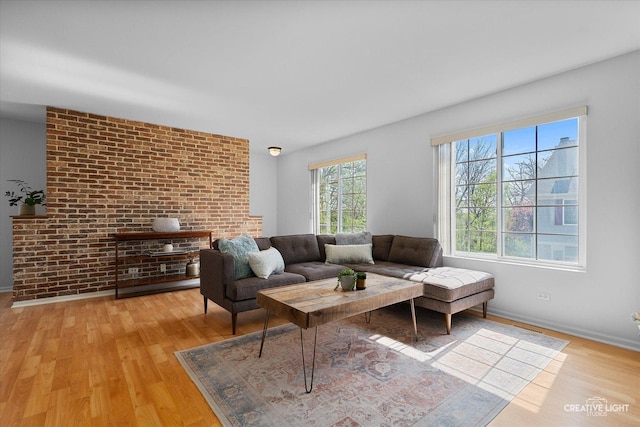 living area featuring light wood-style flooring and baseboards
