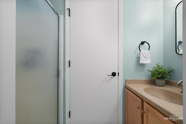 bathroom with vanity and an enclosed shower