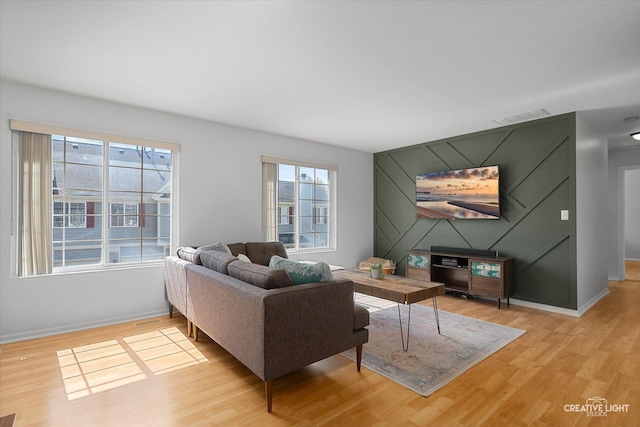 living area featuring light wood-type flooring and baseboards