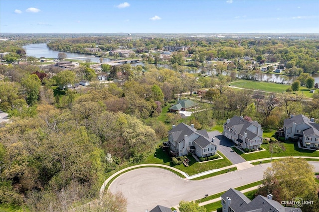 aerial view of residential area featuring a large body of water