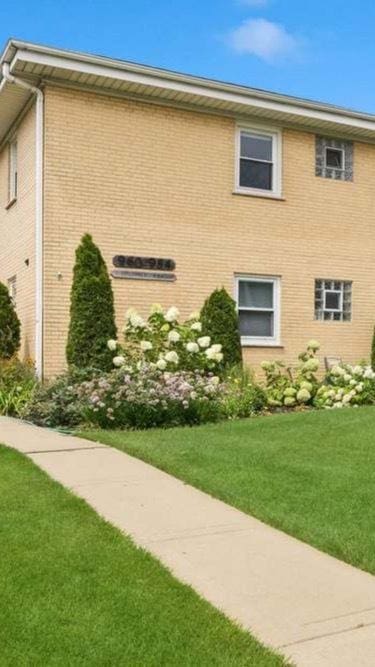 960 Shermer Rd Unit 2, Glenview, IL 60025 - view of side of home featuring a yard and brick siding