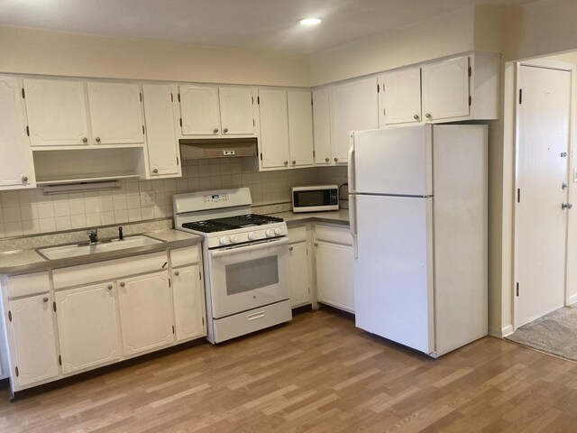 960 Shermer Rd Unit 2, Glenview, IL 60025 - kitchen featuring white appliances, a sink, light wood-style floors, white cabinetry, and tasteful backsplash