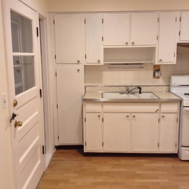 960 Shermer Rd Unit 2, Glenview, IL 60025 - kitchen featuring white electric stove, a sink, white cabinetry, and light countertops