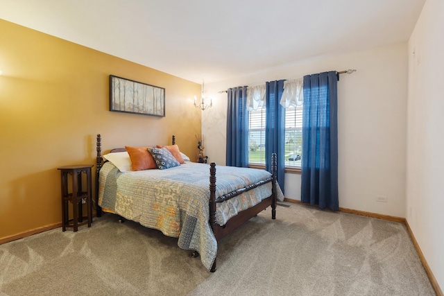 carpeted bedroom featuring baseboards
