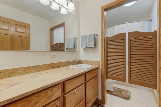 full bath with vanity, toilet, tile patterned floors, and a chandelier