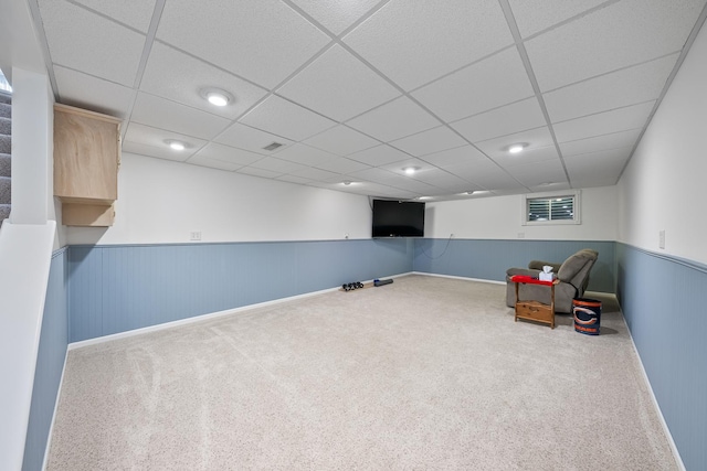 interior space featuring a paneled ceiling, wainscoting, visible vents, and carpet floors