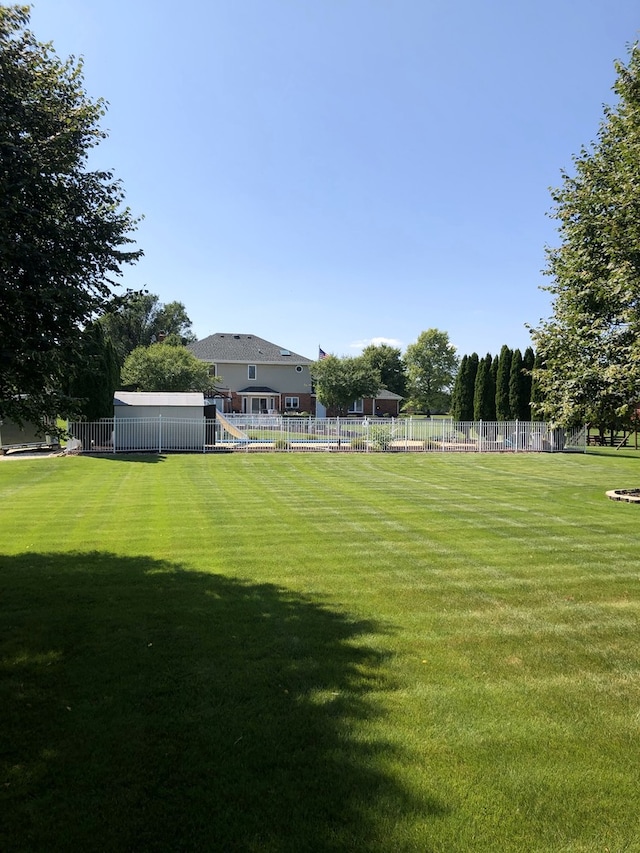 view of yard featuring fence and playground community