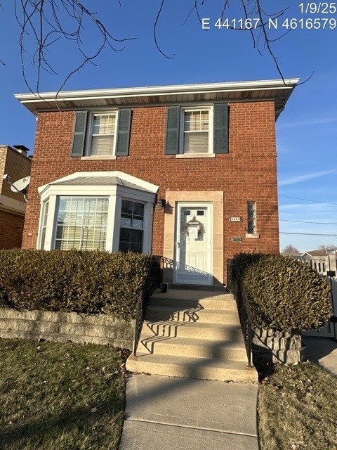 view of front of home featuring brick siding