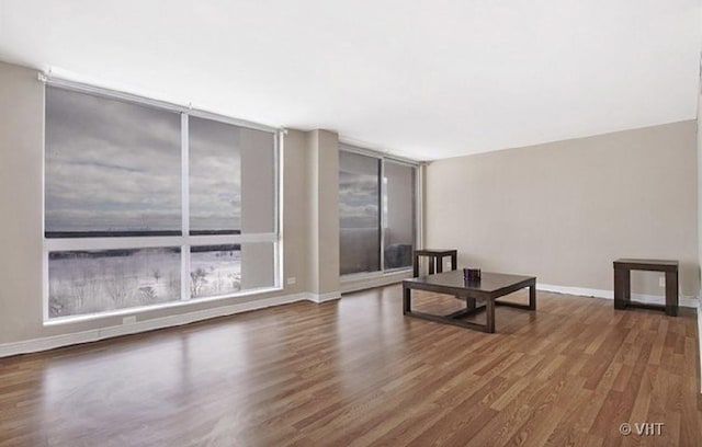 465 W Dominion Dr Unit 1302, Wood Dale, IL 60191 - unfurnished living room with wood finished floors and baseboards
