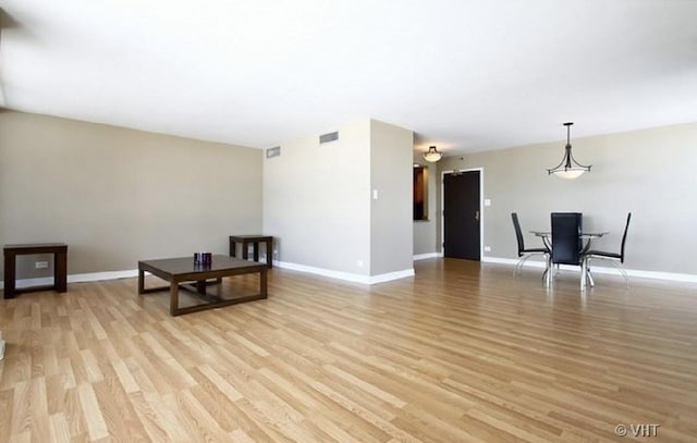 465 W Dominion Dr Unit 1302, Wood Dale, IL 60191 - unfurnished living room featuring visible vents, baseboards, and light wood-style floors