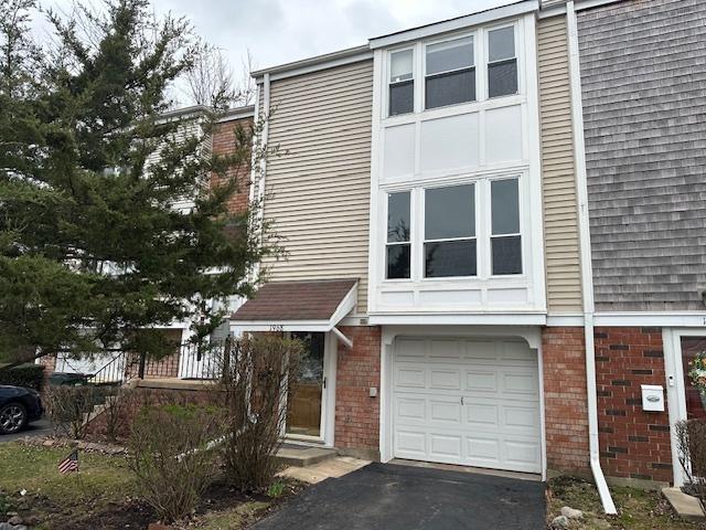 1968 Holbrook Ln, Hoffman Estates, IL 60169 - view of front facade with a garage, driveway, and brick siding