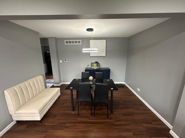 1968 Holbrook Ln, Hoffman Estates, IL 60169 - dining room featuring wood finished floors, baseboards, and visible vents