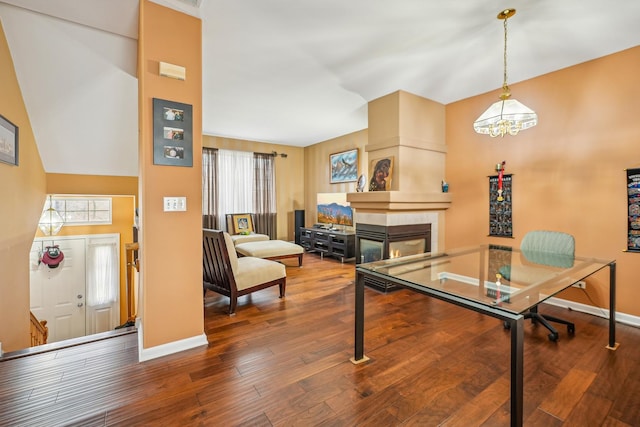 interior space featuring a tiled fireplace, baseboards, plenty of natural light, and hardwood / wood-style floors