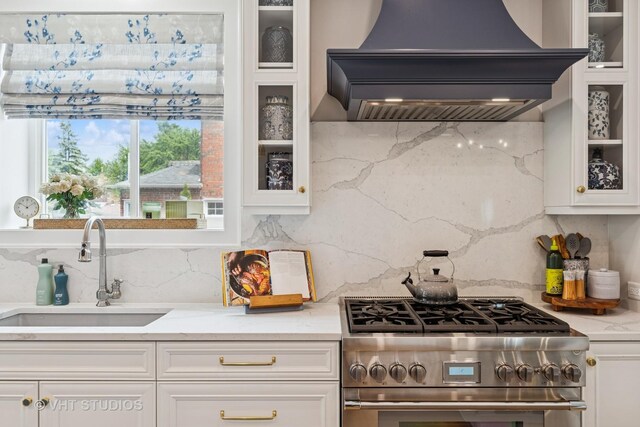 10044 S Leavitt St, Chicago, IL 60643 - kitchen with custom exhaust hood, high end range, a sink, and white cabinets