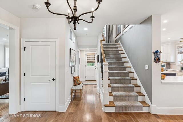 10044 S Leavitt St, Chicago, IL 60643 - stairs with a chandelier, wood finished floors, recessed lighting, and baseboards