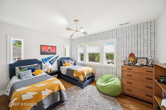 10044 S Leavitt St, Chicago, IL 60643 - bedroom with wallpapered walls, an accent wall, multiple windows, wood finished floors, and baseboards
