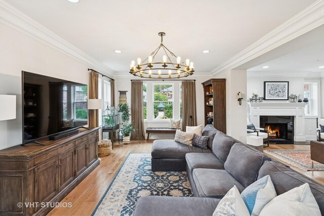 10044 S Leavitt St, Chicago, IL 60643 - living room with a fireplace with flush hearth, a chandelier, light wood-type flooring, recessed lighting, and crown molding