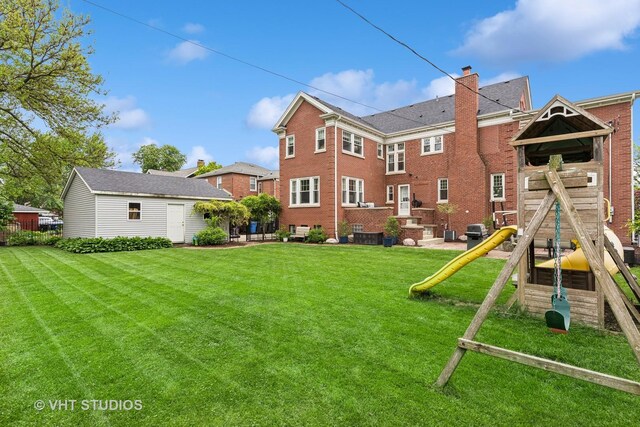 10044 S Leavitt St, Chicago, IL 60643 - back of house featuring a playground, a lawn, a chimney, and brick siding