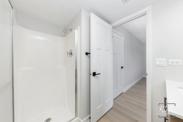 1221 Chalet Rd Unit 28-201, Naperville, IL 60563 - bathroom with vanity, a stall shower, and wood finished floors