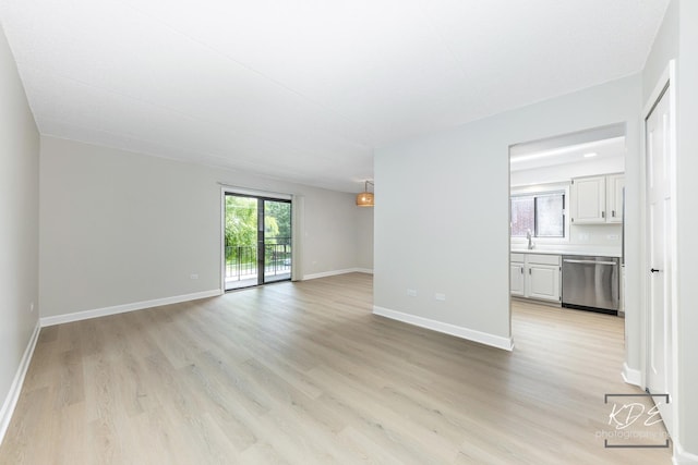 1221 Chalet Rd Unit 28-201, Naperville, IL 60563 - unfurnished living room featuring light wood-style flooring and baseboards