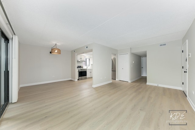 1221 Chalet Rd Unit 28-201, Naperville, IL 60563 - unfurnished living room featuring light wood-style floors and baseboards