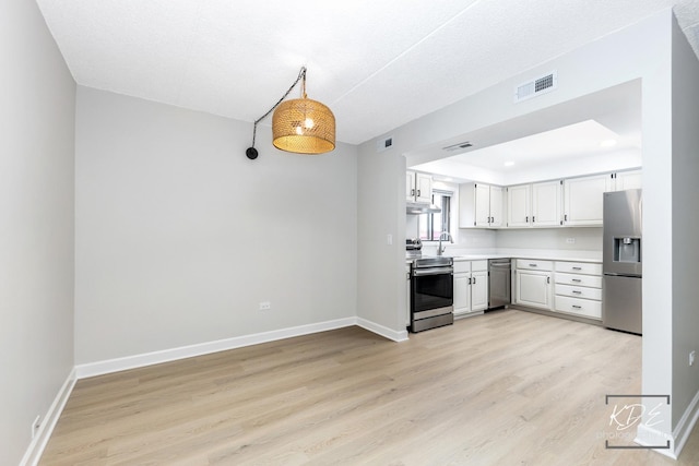 1221 Chalet Rd Unit 28-201, Naperville, IL 60563 - kitchen featuring stainless steel appliances, light wood-type flooring, light countertops, white cabinets, and under cabinet range hood