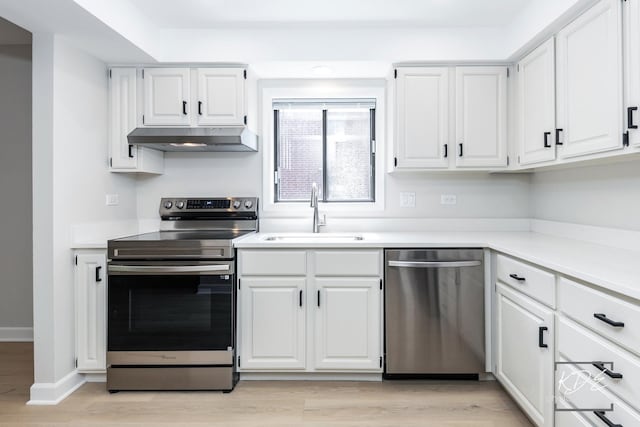 1221 Chalet Rd Unit 28-201, Naperville, IL 60563 - kitchen featuring appliances with stainless steel finishes, under cabinet range hood, white cabinets, and light wood finished floors