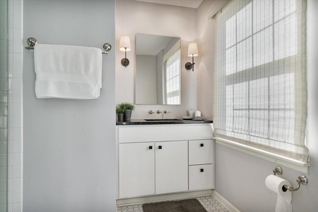full bathroom featuring vanity and baseboards