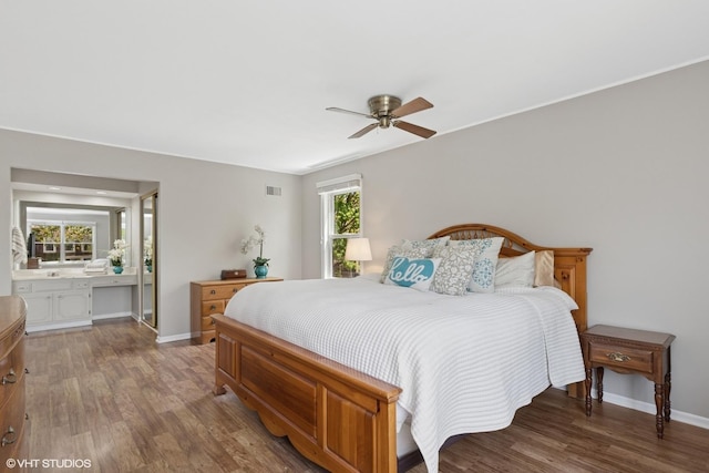 1900 Buckingham Rd, Mundelein, IL 60060 - bedroom with wood finished floors, baseboards, ensuite bathroom, and ceiling fan