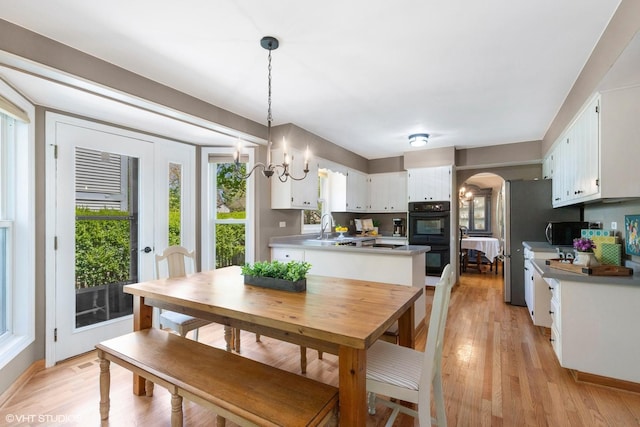 1900 Buckingham Rd, Mundelein, IL 60060 - dining room featuring arched walkways, light wood-style flooring, and baseboards