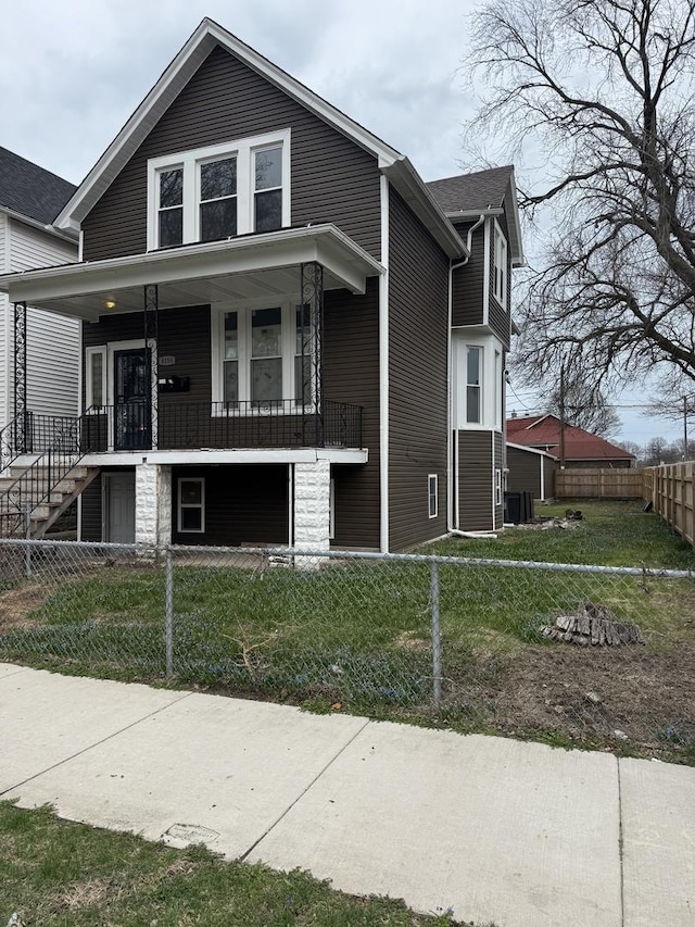 view of home's exterior featuring a fenced front yard, covered porch, and central air condition unit