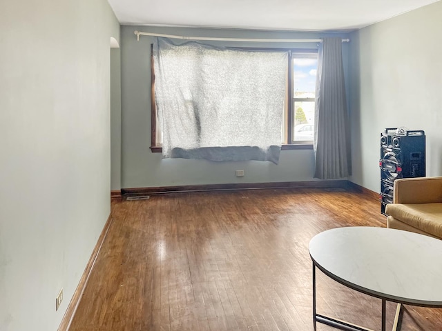 interior space with hardwood / wood-style flooring and baseboards