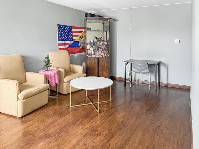 living area featuring wood finished floors and baseboards