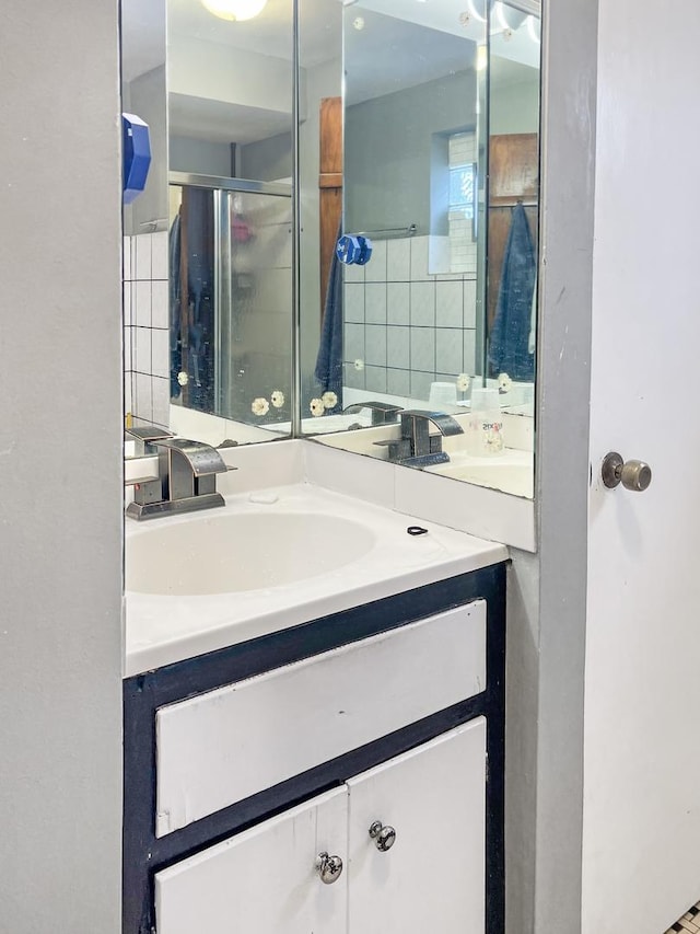 bathroom featuring an enclosed shower and vanity