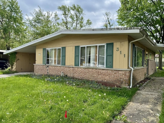 311 Seneca St, Park Forest, IL 60466 - view of property exterior with brick siding, an attached carport, a lawn, and driveway