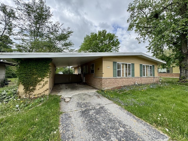 311 Seneca St, Park Forest, IL 60466 - view of front of property with brick siding, concrete driveway, an attached carport, and a front yard