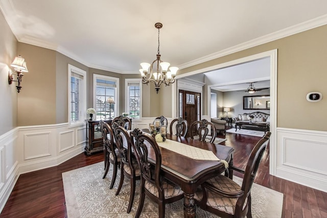 22814 Sara Springs Dr, Frankfort, IL 60423 - dining area featuring a chandelier, wainscoting, dark wood-type flooring, crown molding, and a decorative wall