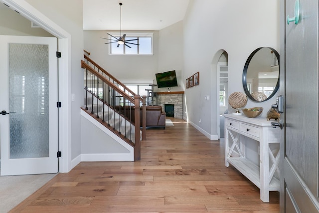 3605 Como Ct, Normal, IL 61761 - entrance foyer featuring a towering ceiling, ceiling fan, stairs, a stone fireplace, and baseboards