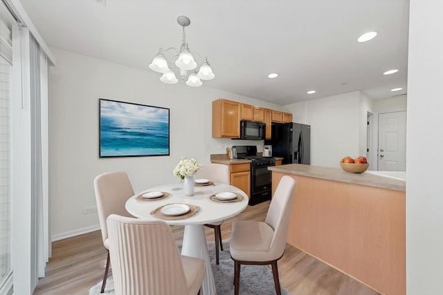 dining area with recessed lighting, light wood-style flooring, baseboards, and an inviting chandelier
