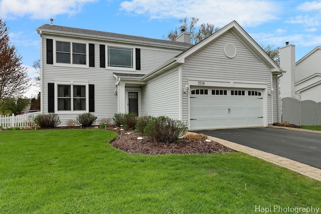 1518 Schafer Ave, Bolingbrook, IL 60490 - view of front facade featuring a front lawn, fence, a chimney, an attached garage, and driveway