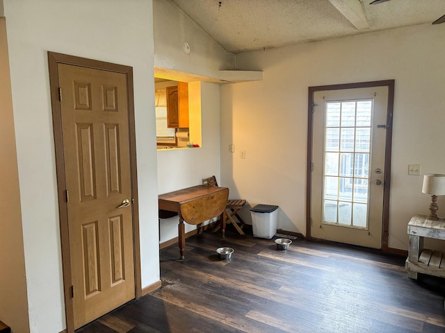 office area featuring baseboards, vaulted ceiling, and dark wood finished floors