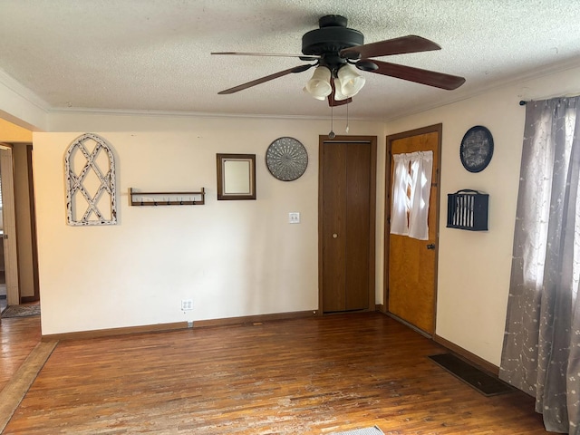 spare room featuring hardwood / wood-style floors, crown molding, a ceiling fan, and a textured ceiling